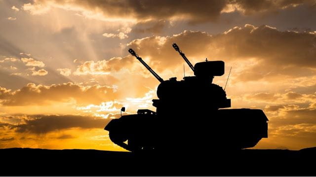 Military tank at sunset